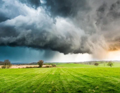 Dramatic Storm Clouds Over A Lush Green Rural Landscape