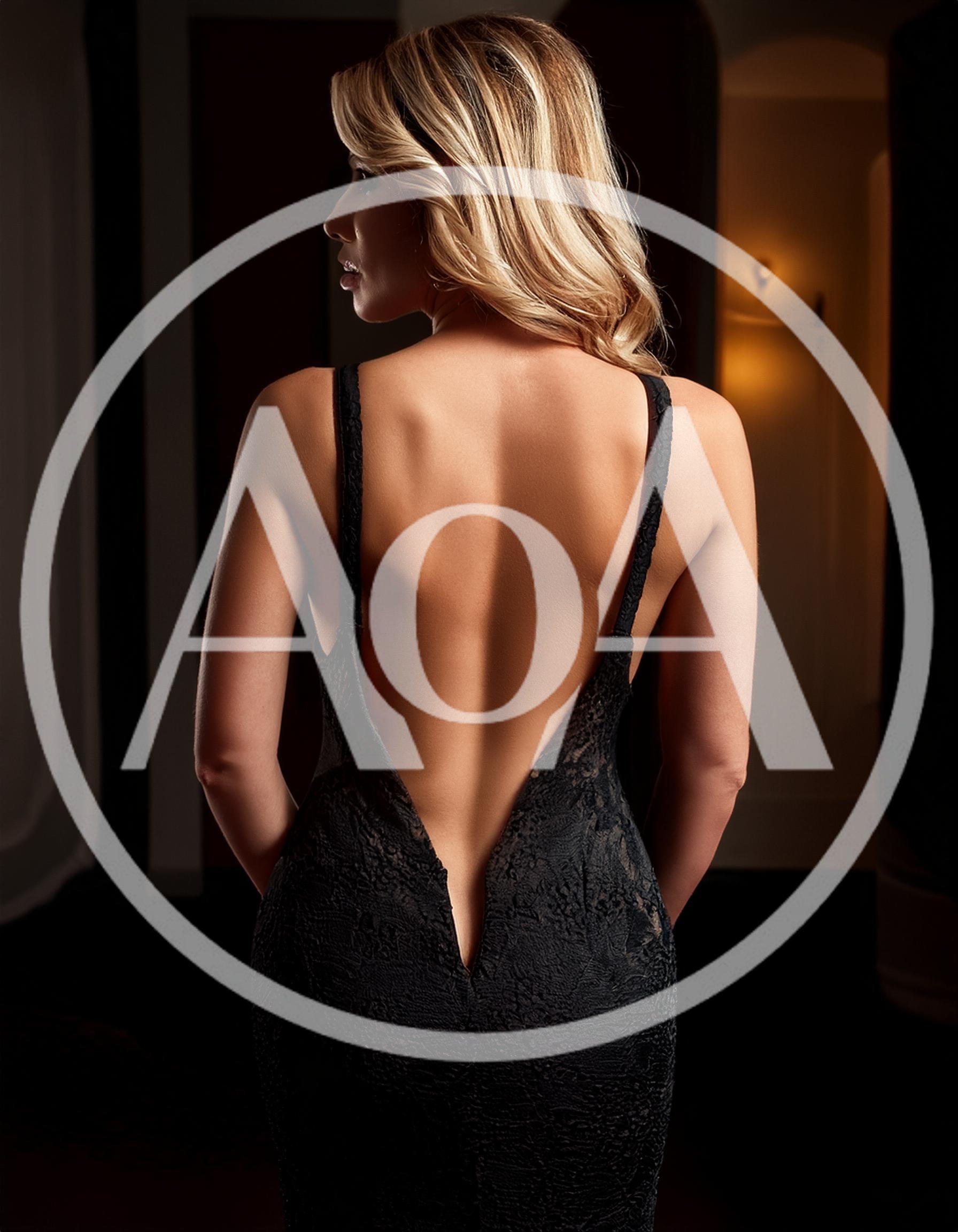 Elegant Blonde Woman In Backless Black Lace Dress