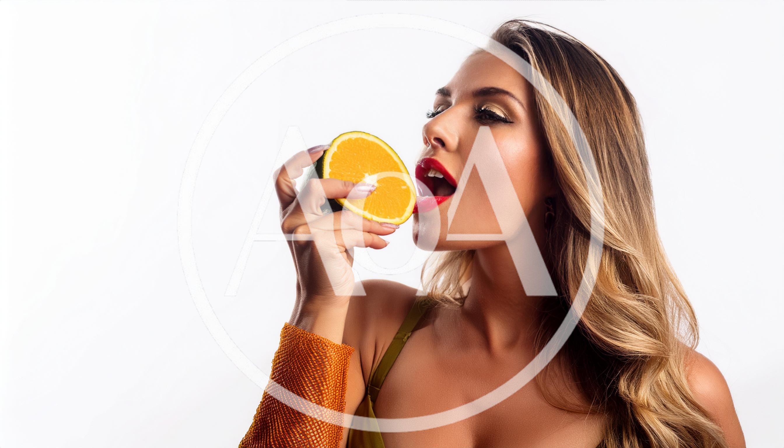 Beautiful Woman Holding A Fresh Orange Slice