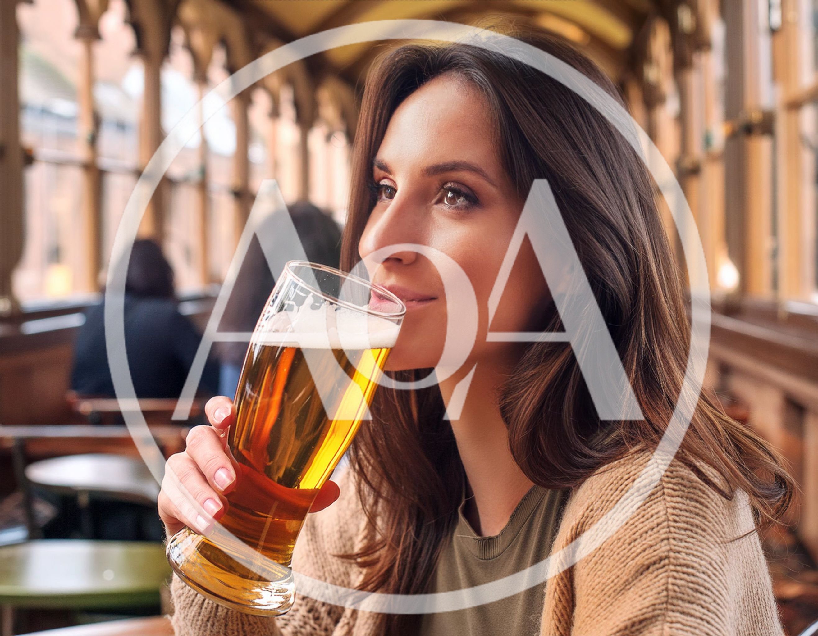 Young Woman Drinking Beer In A Pub