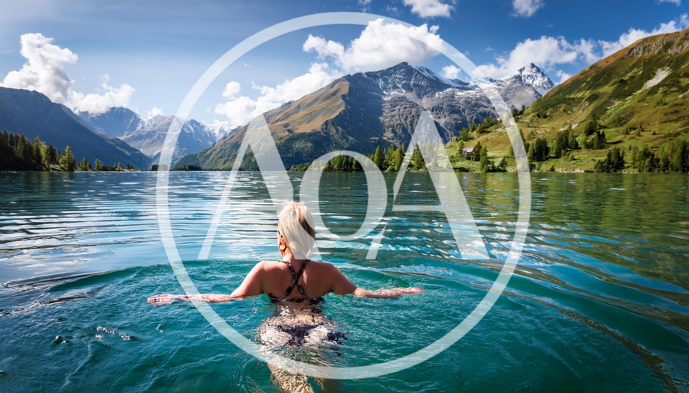 Woman Swimming In A Crystal Clear Alpine Lake