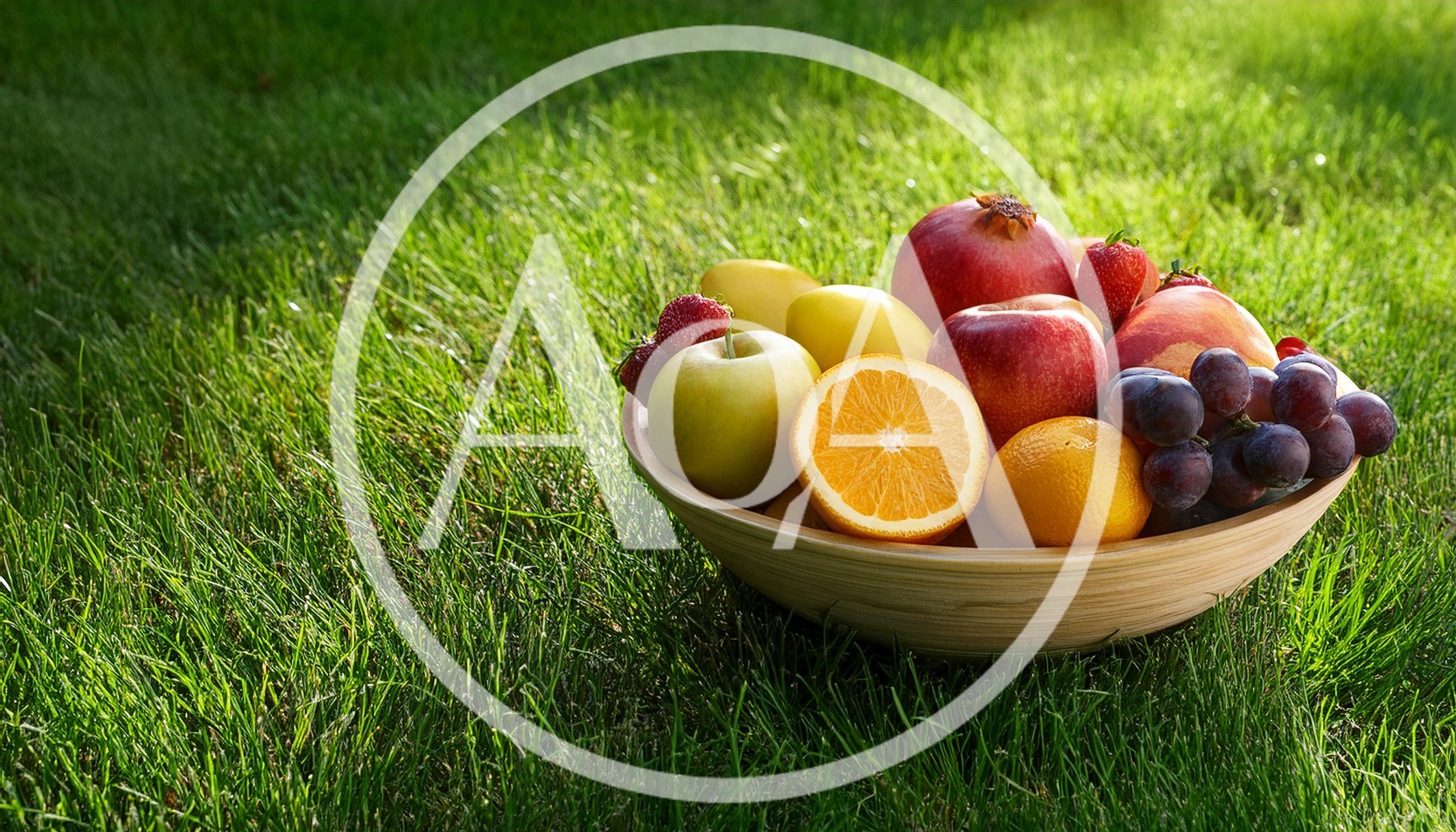 Fresh Fruit Bowl Sitting On Green Grass