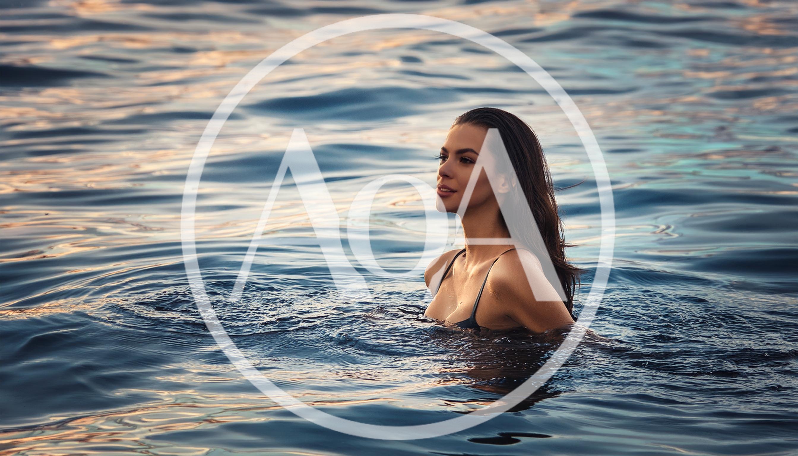 Beautiful Woman Swimming In Calm Ocean At Sunset