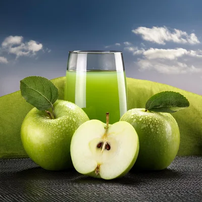 Fresh Green Apples And Juice Glass On Dark Surface