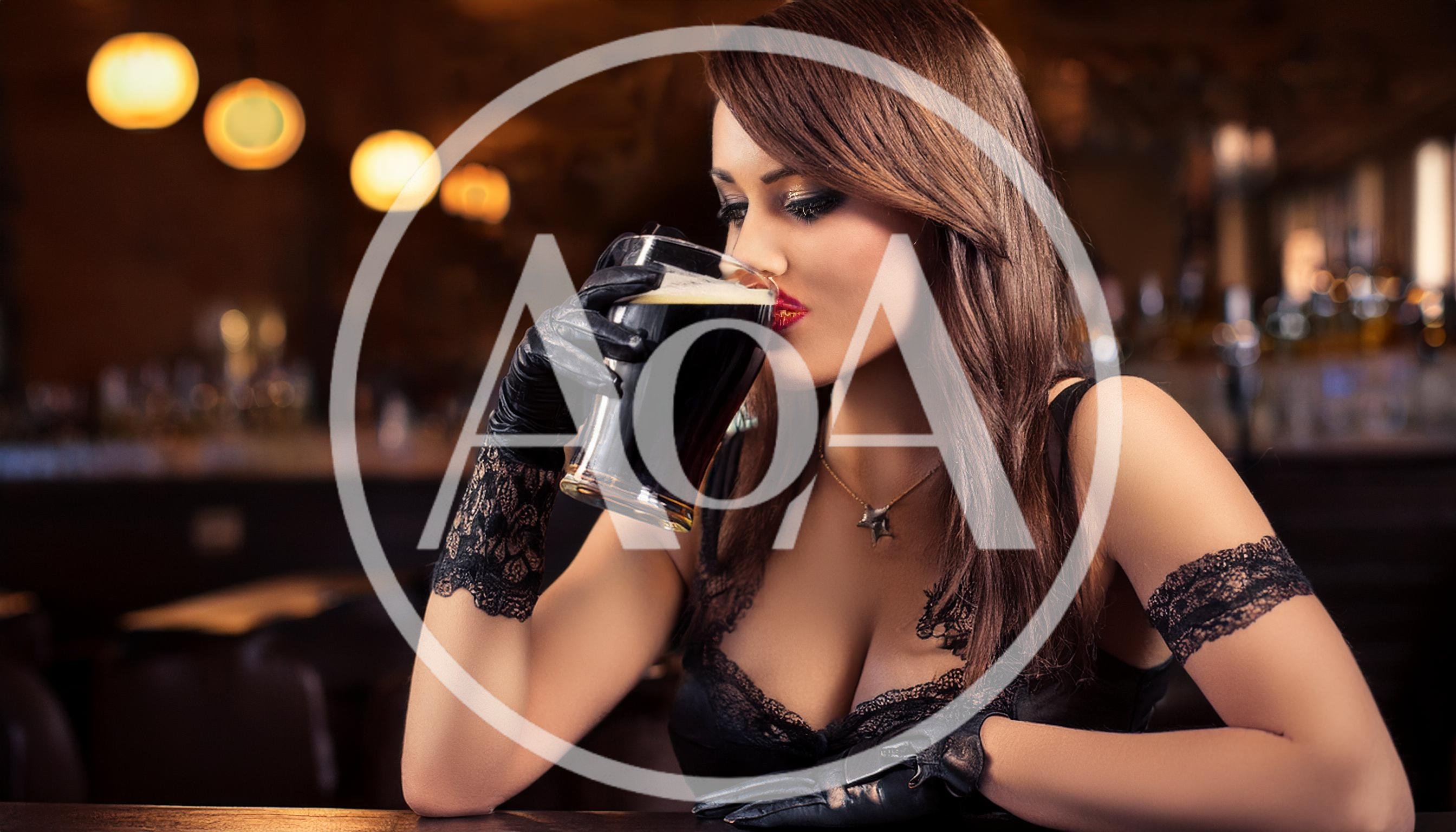 Elegant Woman Drinking Dark Beer In A Dimly Lit Bar