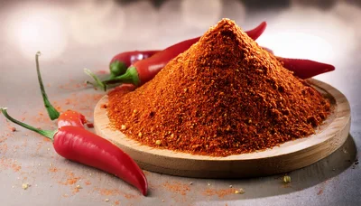 Pile Of Red Chili Powder On Wooden Plate