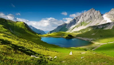 Alpine Lake Surrounded By Lush Green Mountains