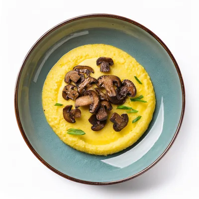 Polenta With Sautéed Mushrooms In A Ceramic Bowl