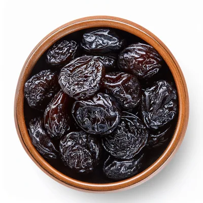 Top View Of Dried Prunes In A Ceramic Bowl