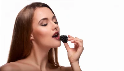 Beautiful Woman Eating A Fresh Blackberry