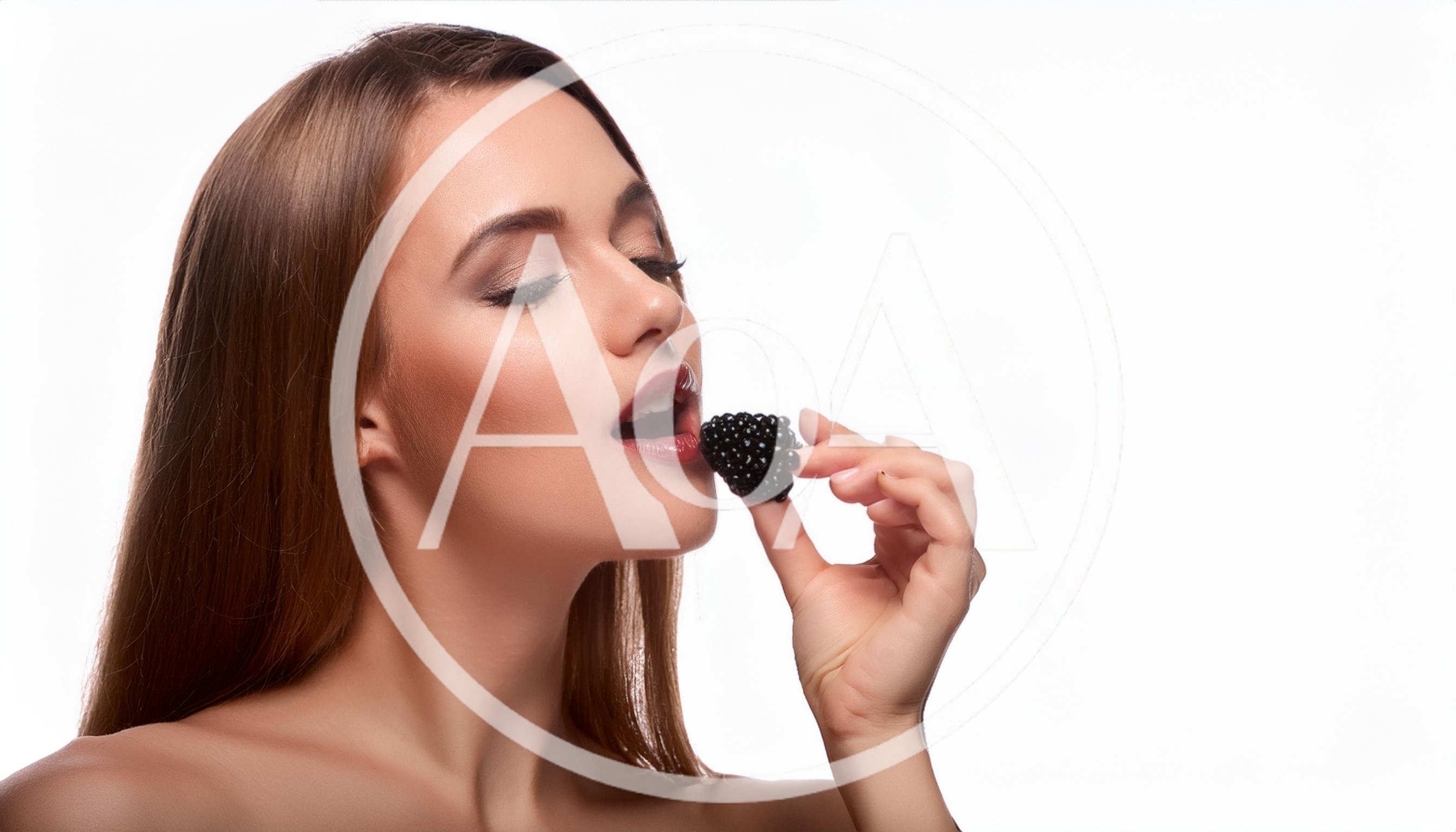 Beautiful Woman Eating A Fresh Blackberry