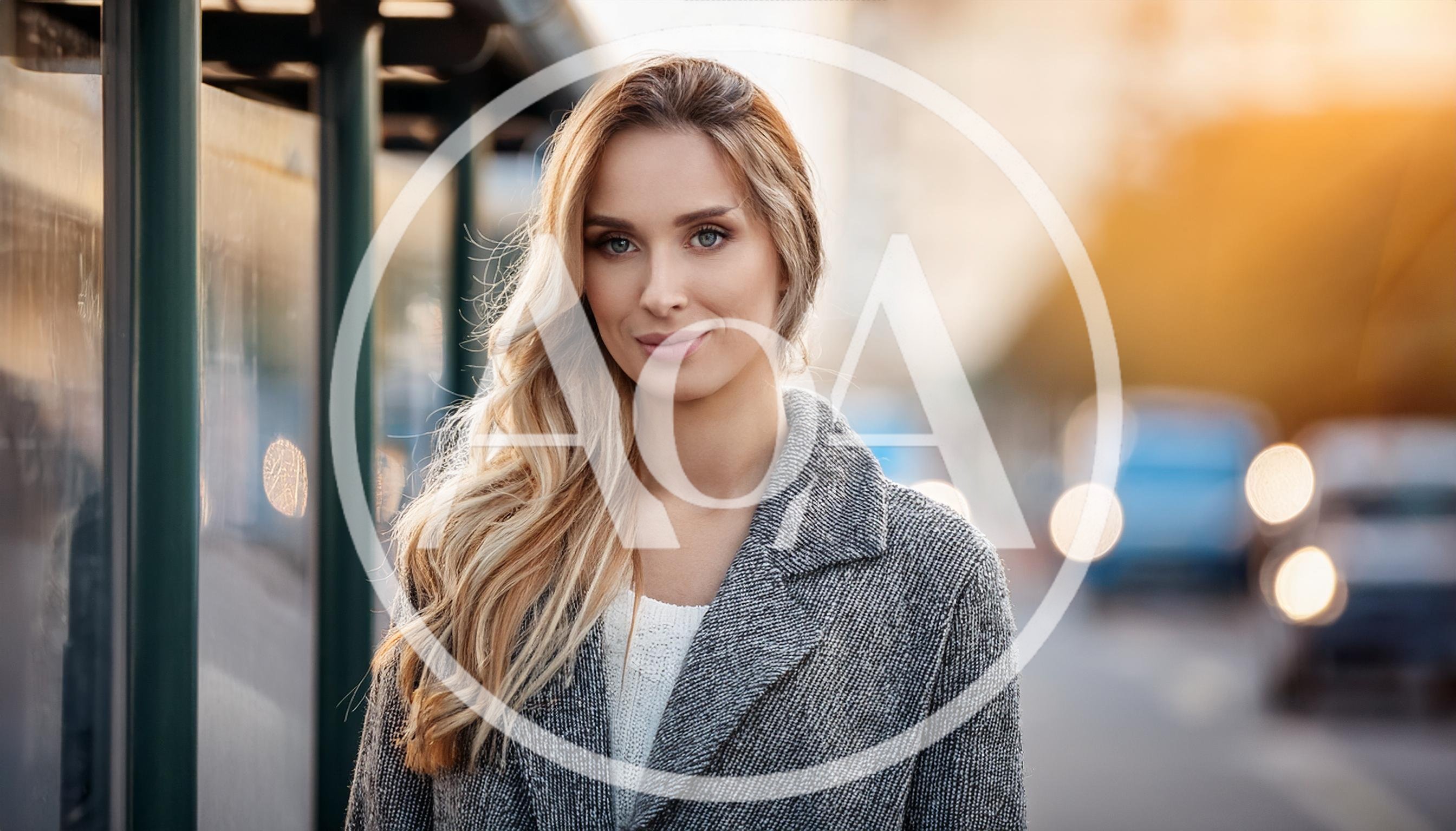 Portrait Of A Beautiful Blonde Woman At A Bus Stop