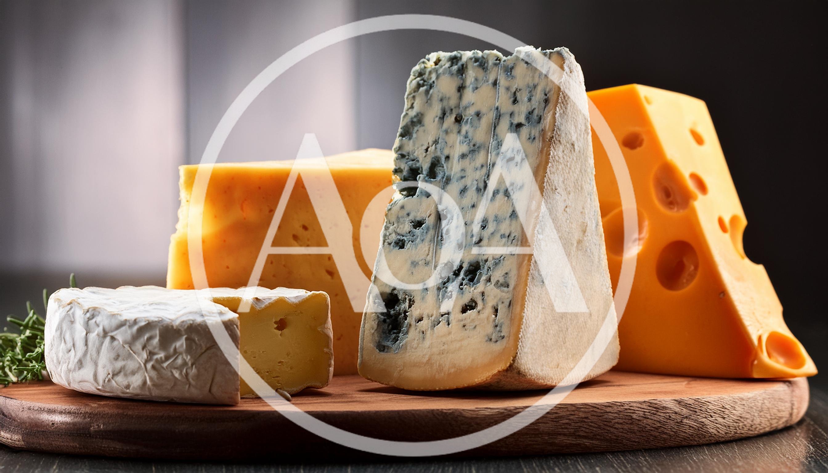 Assorted Cheese Varieties On A Wooden Cutting Board