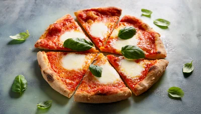 Slices Of Margherita Pizza With Fresh Basil Leaves