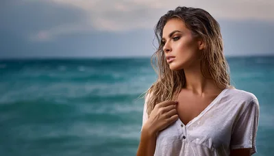 Young Woman With Wet Hair Standing By The Ocean