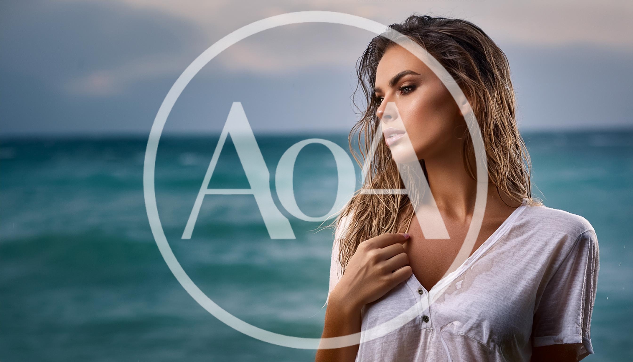 Young Woman With Wet Hair Standing By The Ocean