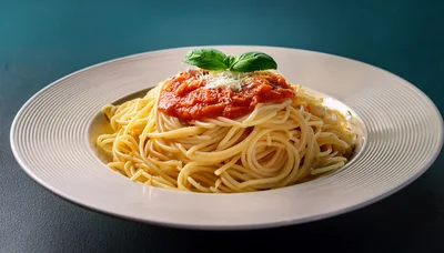 Spaghetti With Tomato Sauce And Basil On A Plate