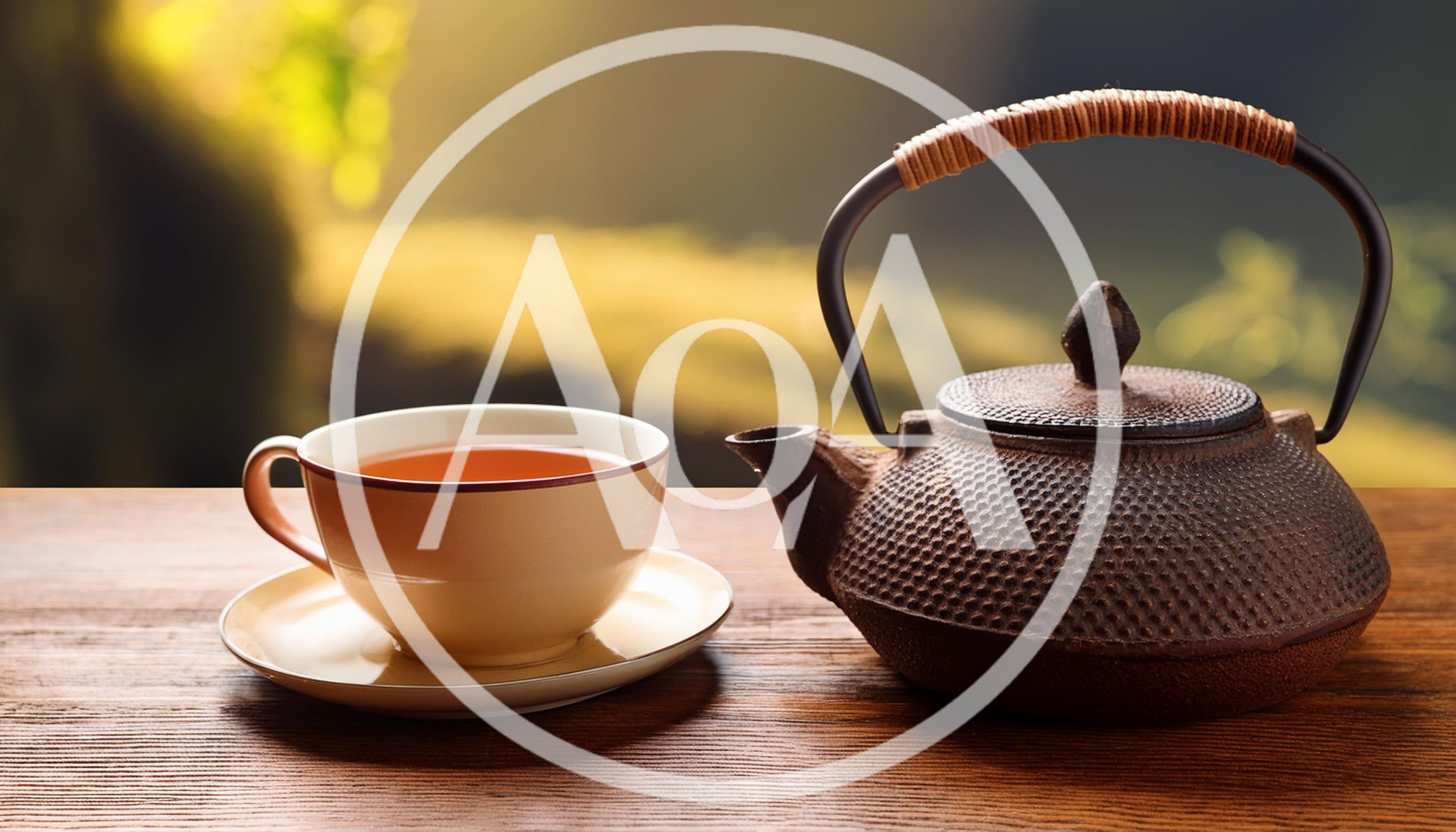 Cast Iron Teapot and Tea Cup on Wooden Table
