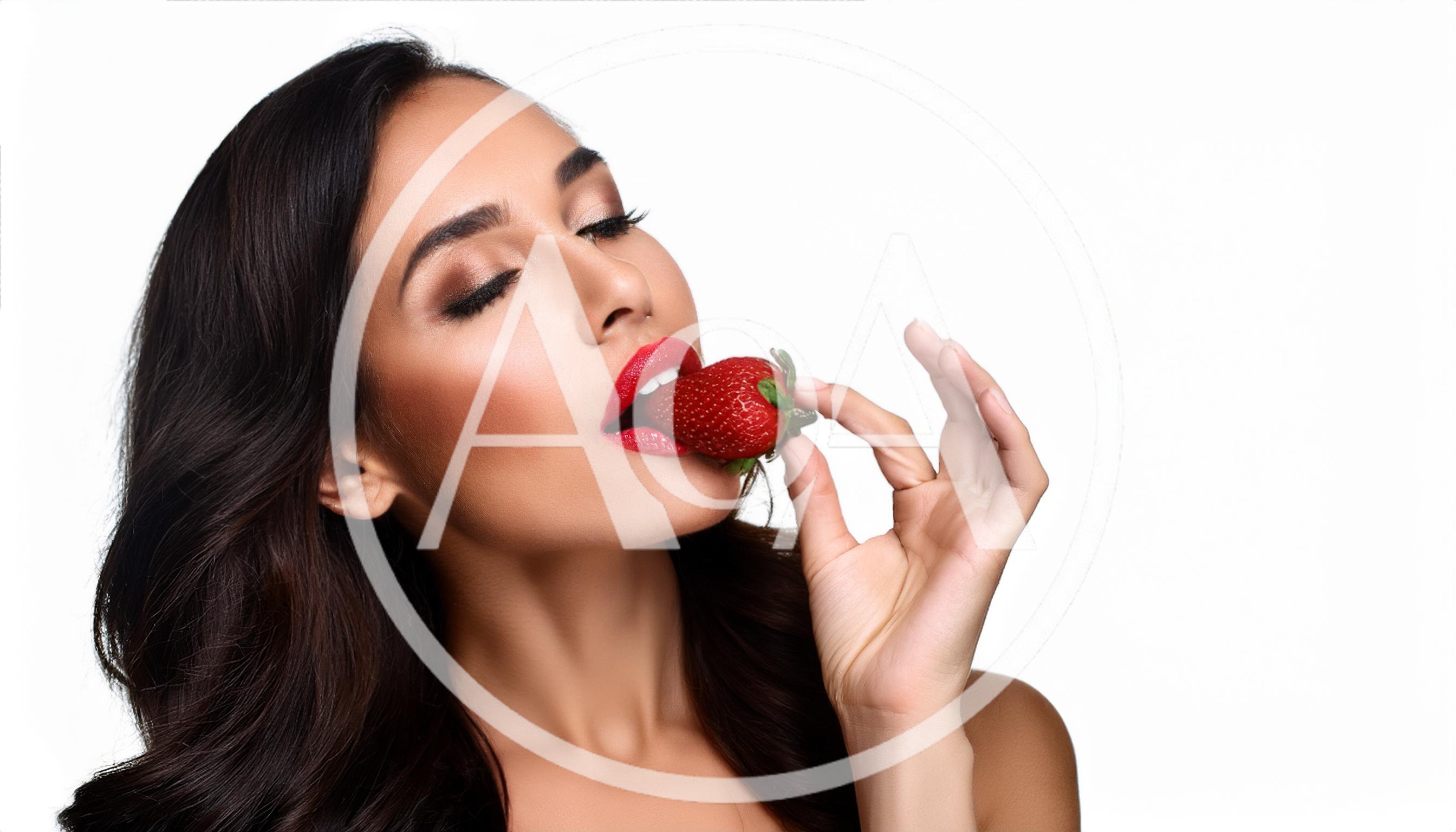 Beautiful Woman Holding A Fresh Strawberry To Her Lips