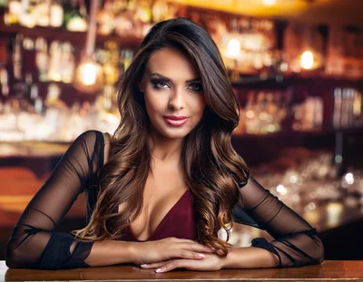 Beautiful Woman Sitting At A Bar Counter