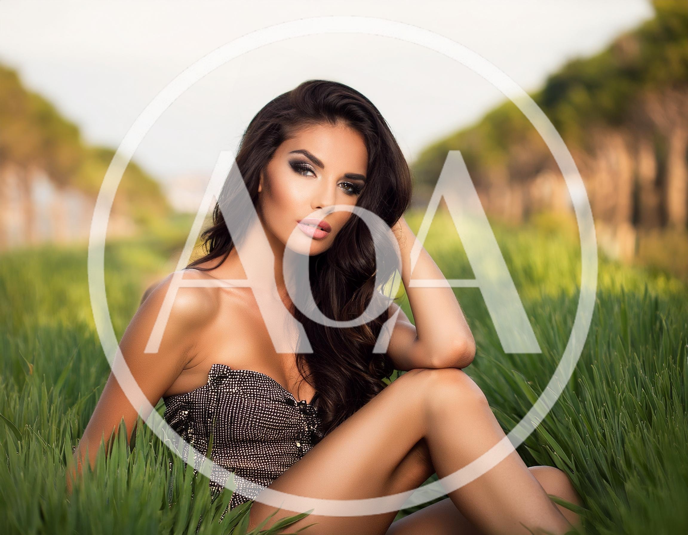 Beautiful Woman Posing In A Grassy Field