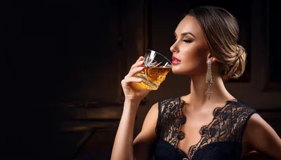 Elegant Woman Drinking Whiskey in a Dimly Lit Room