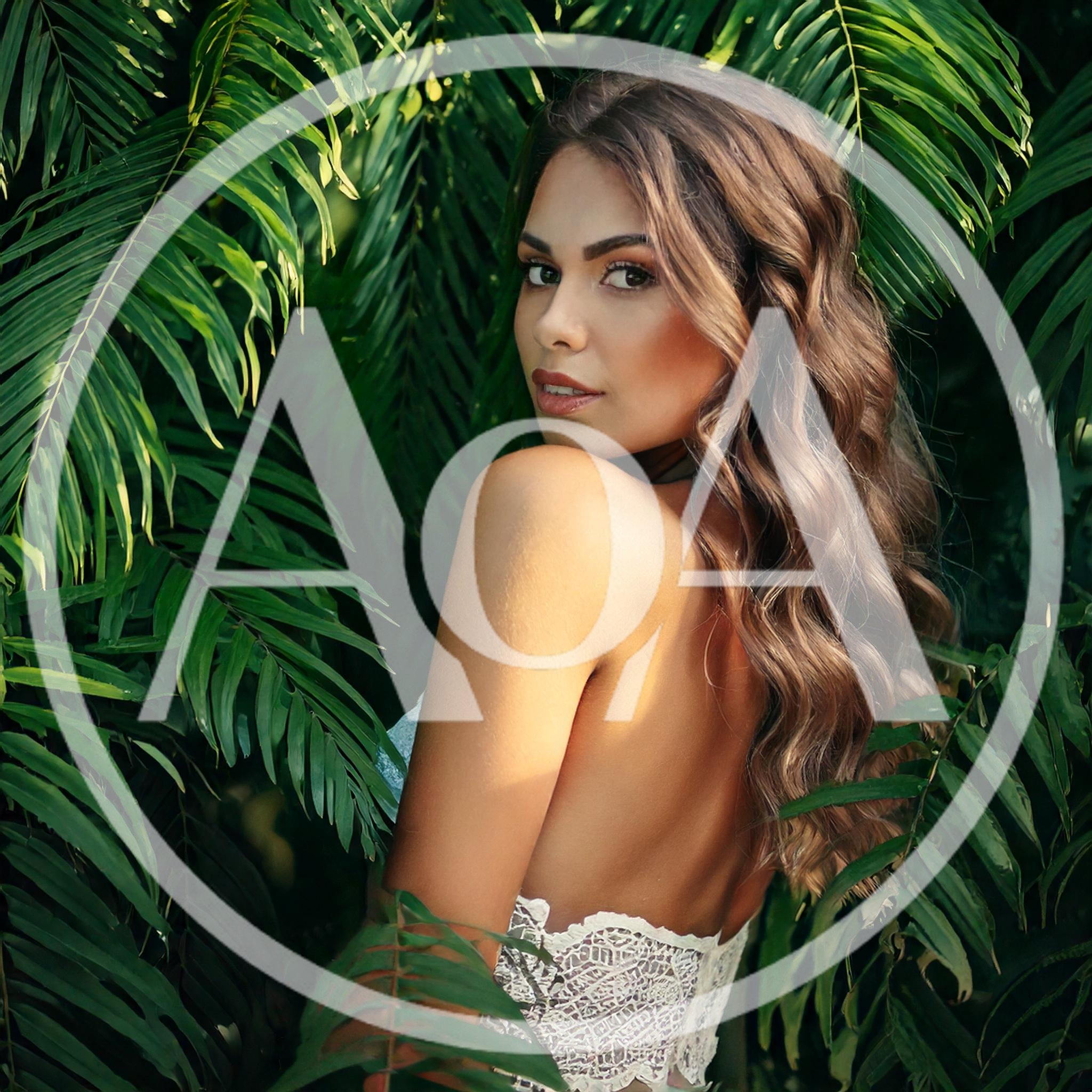 Beautiful Woman Posing Amidst Lush Tropical Palm Leaves