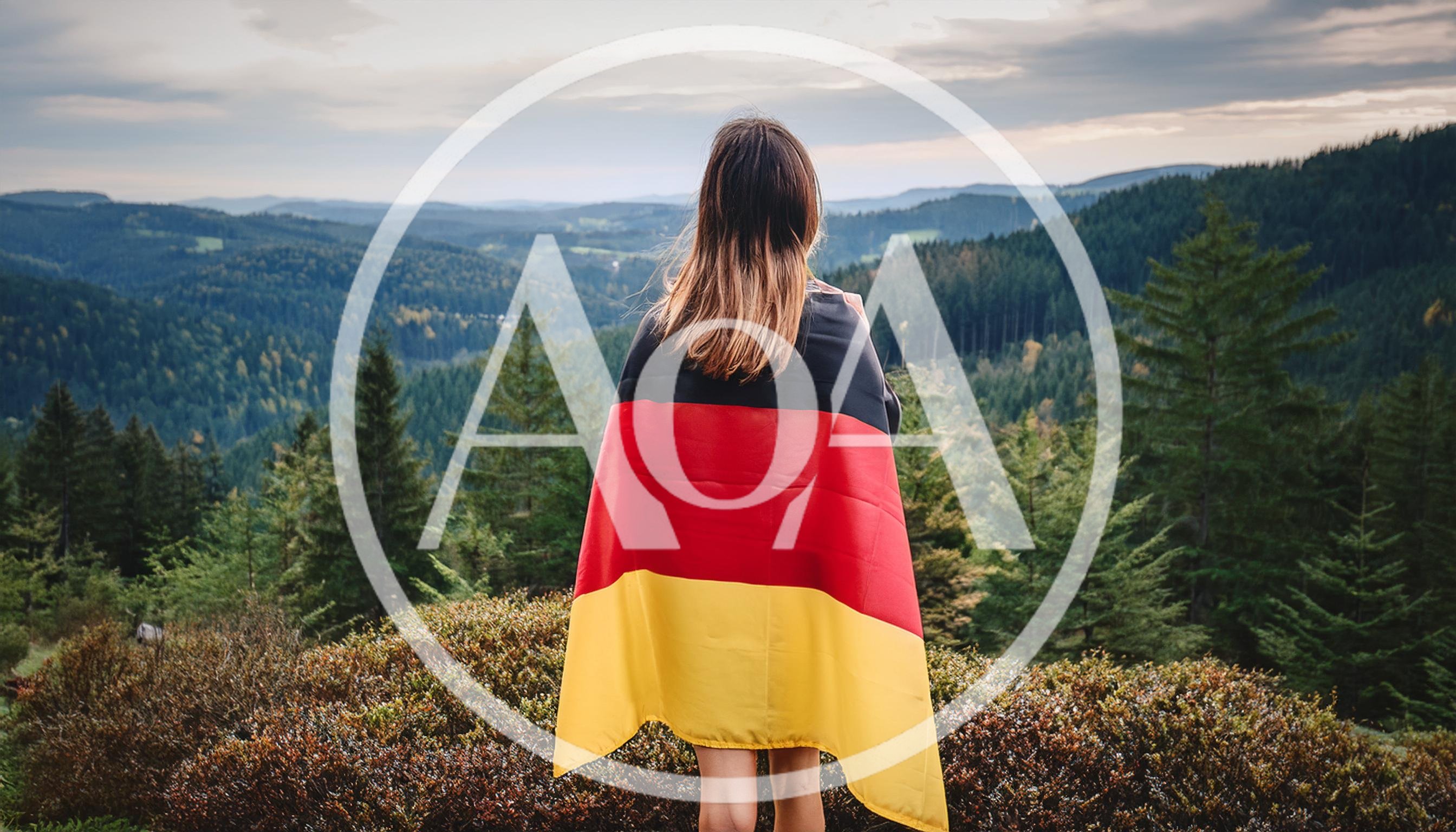 Woman Standing With German Flag Overlooking Forest Landscape