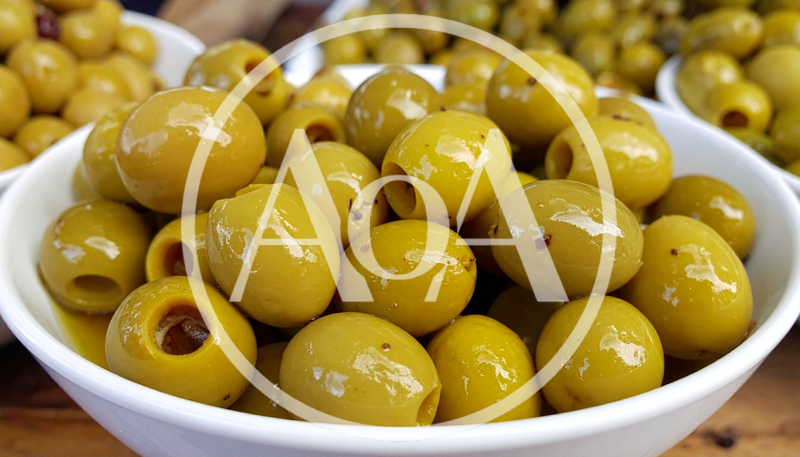 Fresh Pitted Green Olives In A White Bowl