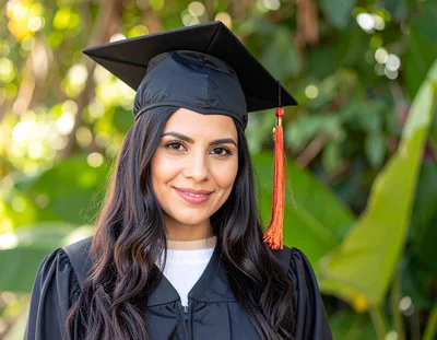 Young Woman Wearing Graduation Cap And Gown
