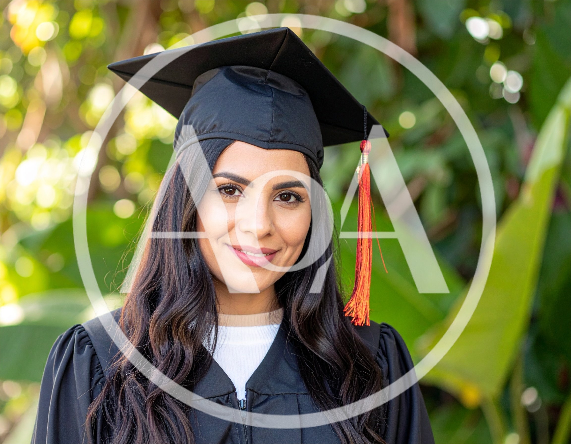 Young Woman Wearing Graduation Cap And Gown