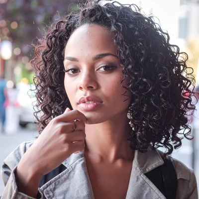 Portrait Of A Young Woman With Curly Hair