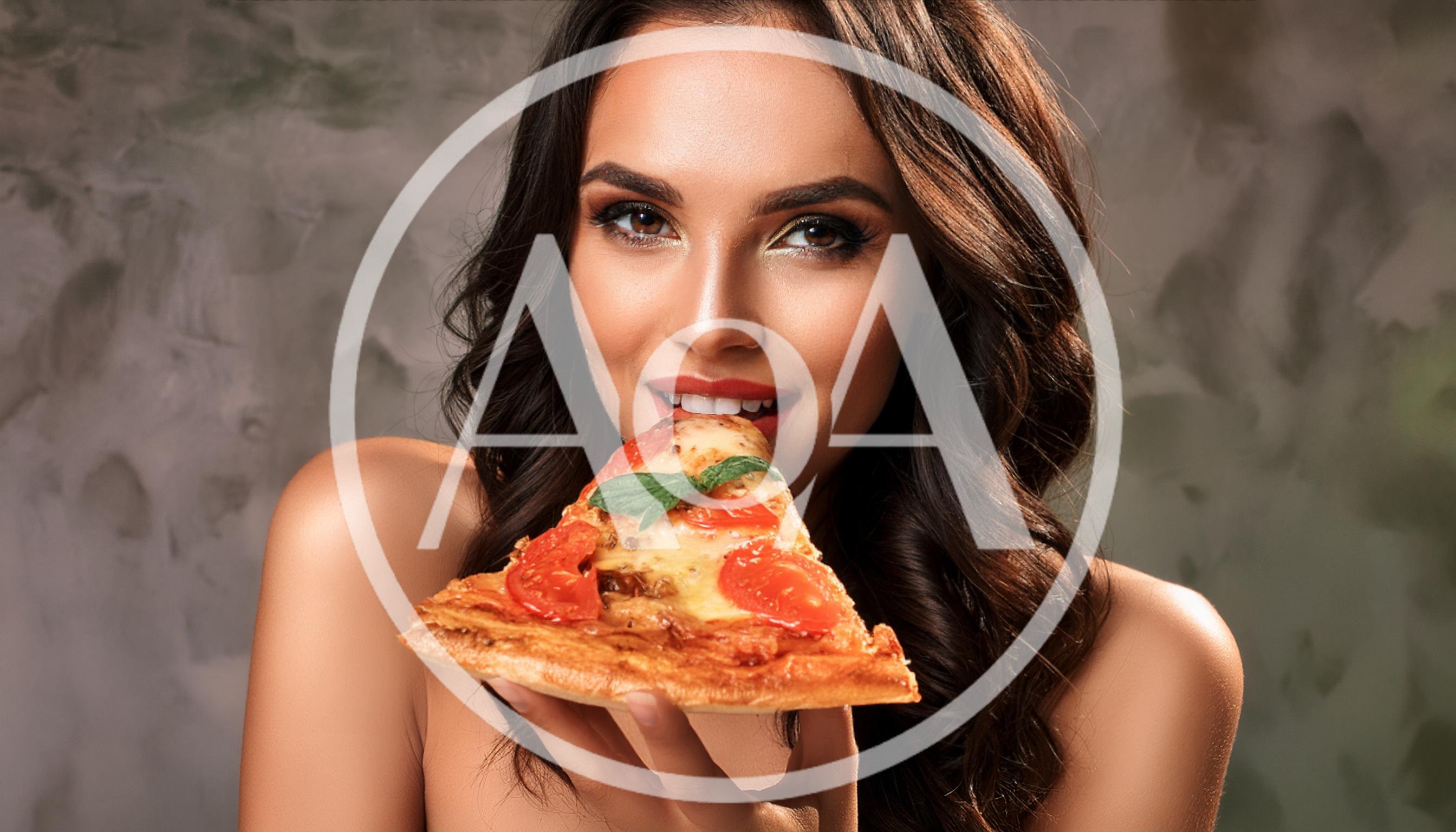 Beautiful Woman Eating A Slice Of Pizza