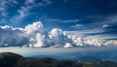 Dramatic Cumulus Clouds Over A Mountain Range