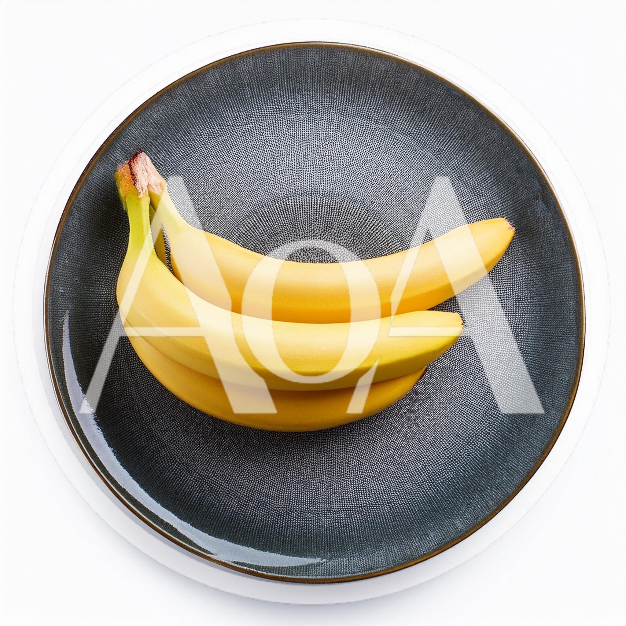 Three Fresh Yellow Bananas On A Textured Dark Plate