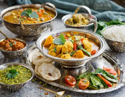 Traditional Indian Thali Platter With Assorted Curries And Bread
