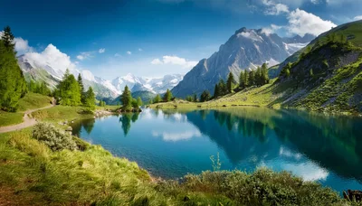 Alpine Lake Surrounded By Lush Green Mountains