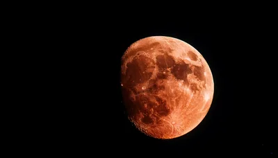 Full Red Moon Against Dark Night Sky