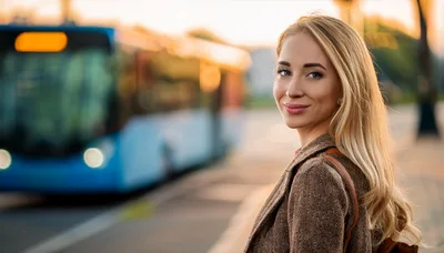 Young Woman Waiting For A Bus At Sunset