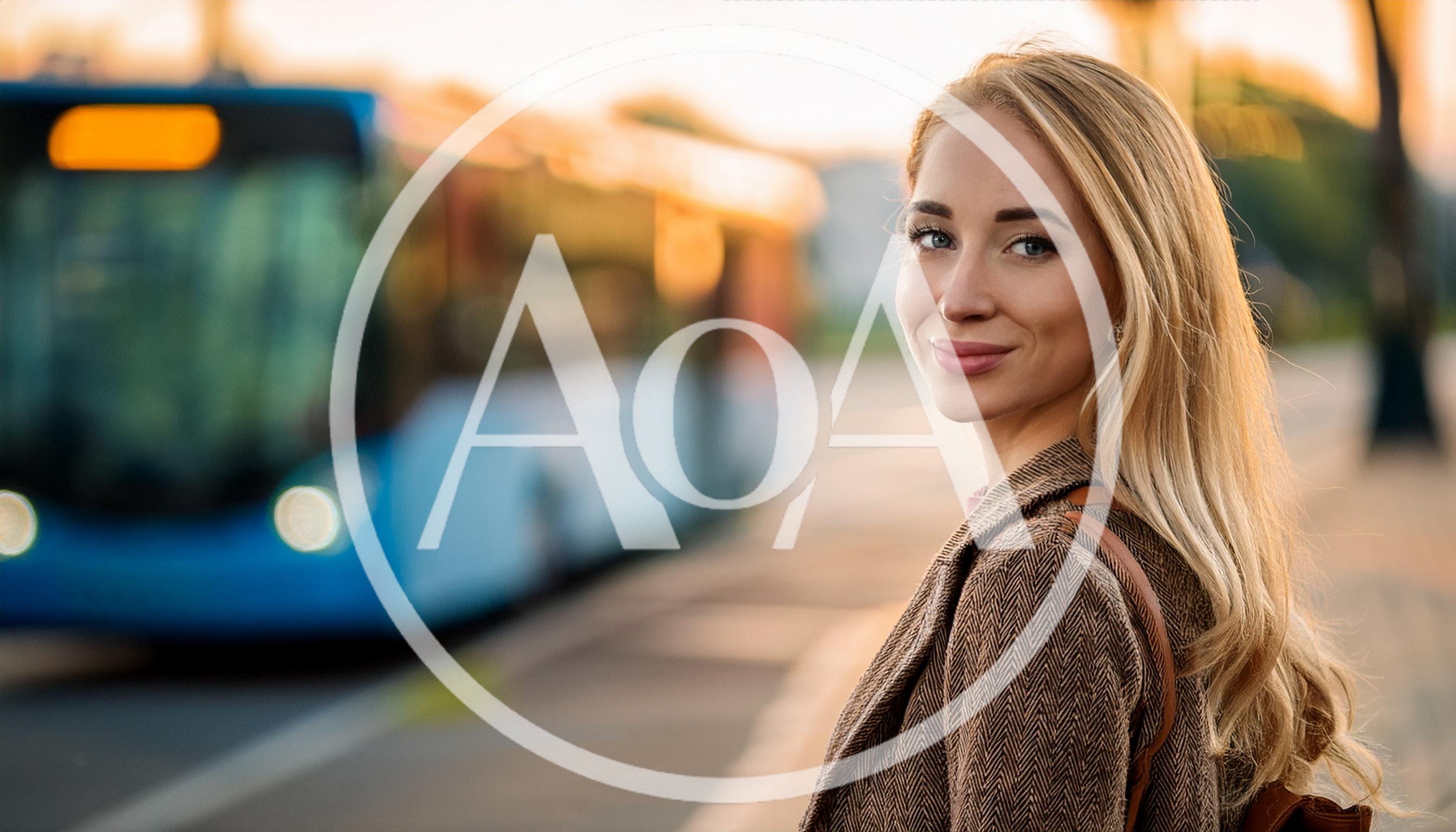 Young Woman Waiting For A Bus At Sunset