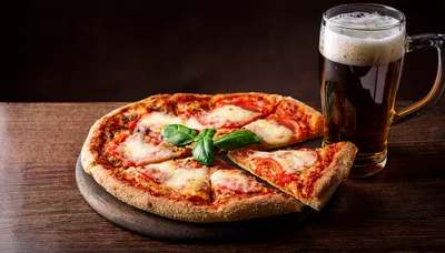 Fresh Pizza With Basil And A Glass Of Beer