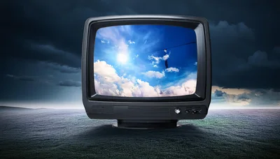 Vintage Television Displaying Sunny Sky In Dark Landscape