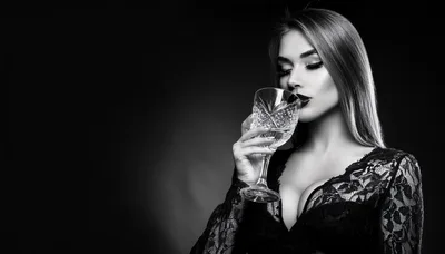 Elegant Woman Drinking From A Crystal Glass