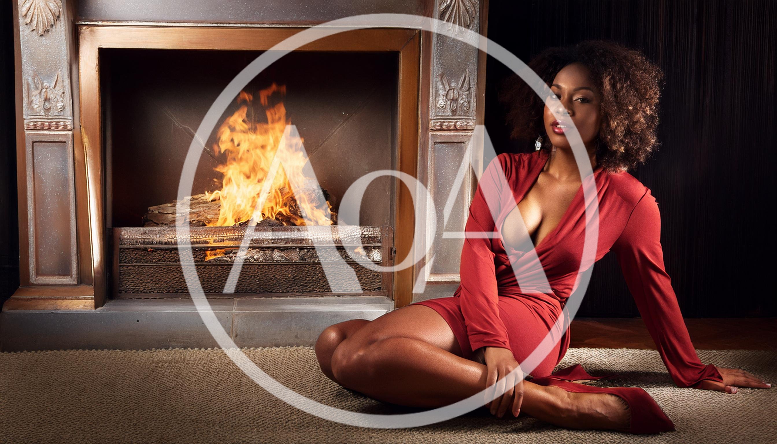 Elegant Woman Sitting By A Cozy Fireplace