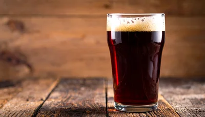 Glass of Dark Stout Beer on Rustic Wooden Table