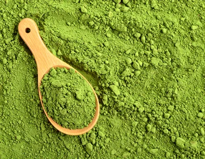 Wooden Spoon Filled With Vibrant Green Matcha Powder