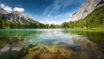 Crystal Clear Alpine Lake With Mountain Backdrop