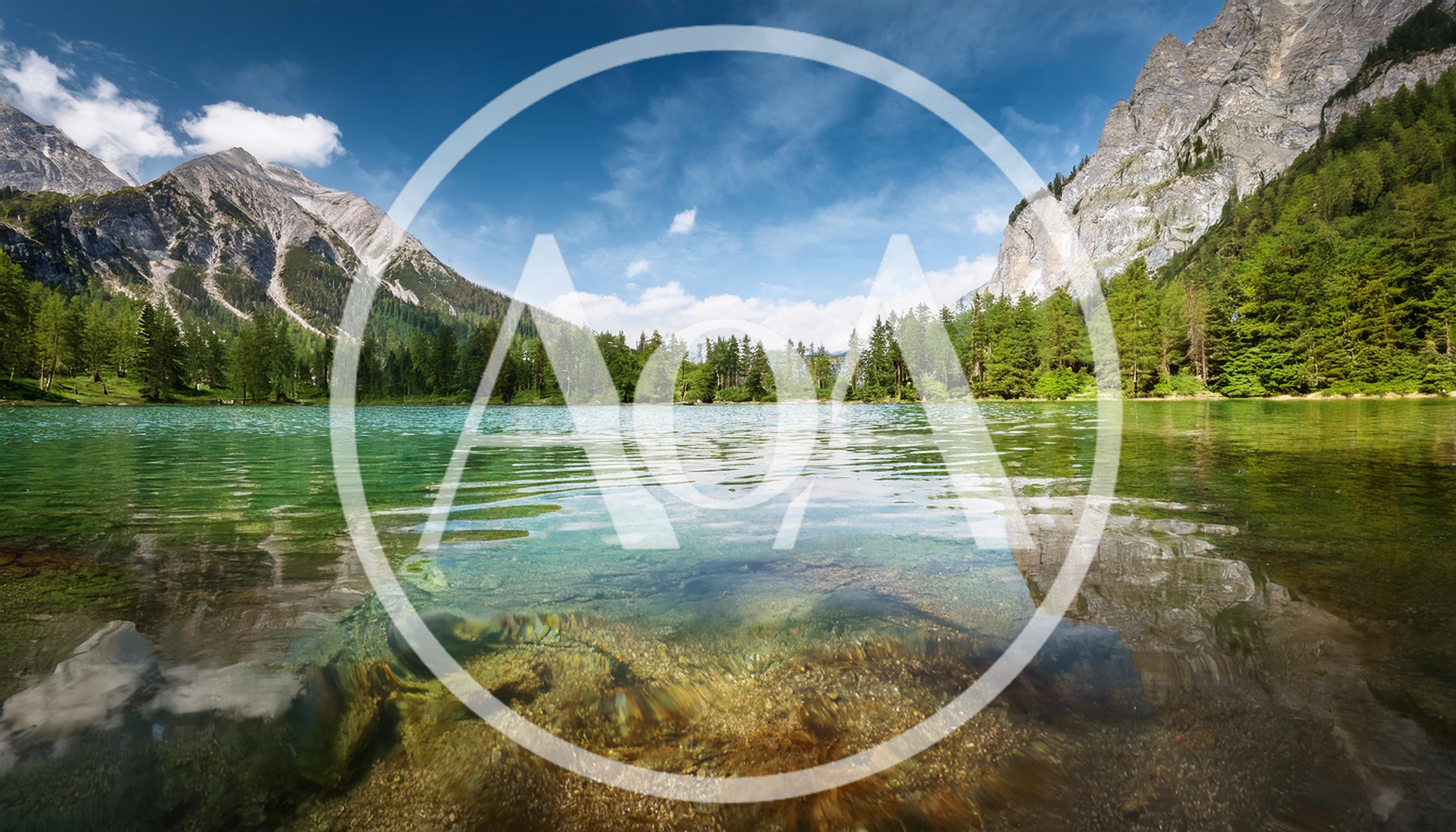 Crystal Clear Alpine Lake With Mountain Backdrop