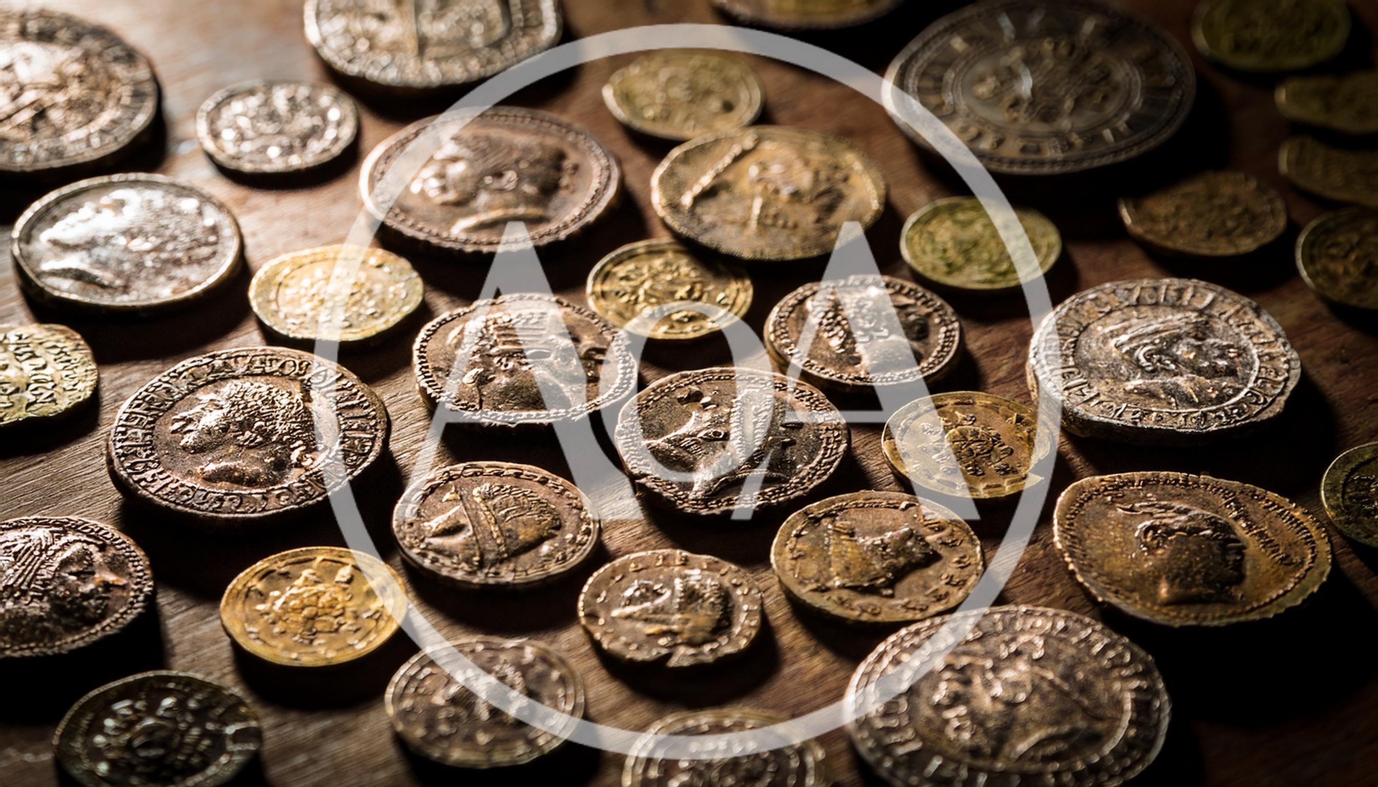 Collection of Ancient Roman Coins on Wooden Surface