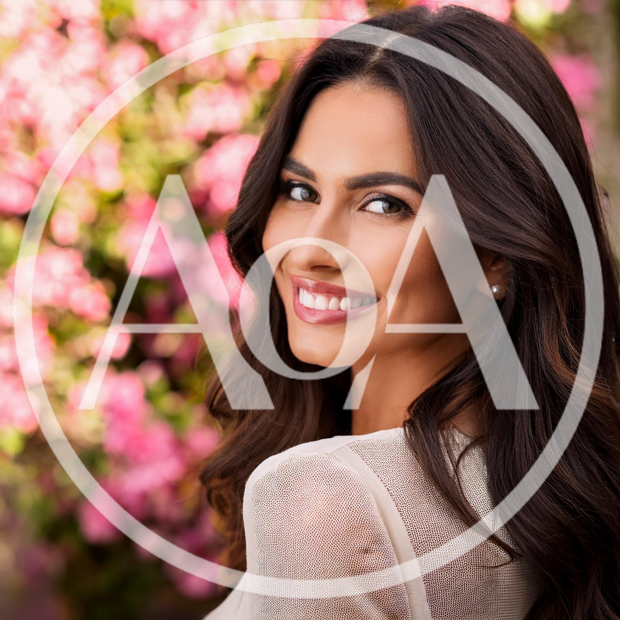 Portrait Of A Smiling Woman With Long Dark Hair
